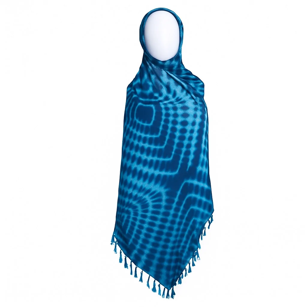Blue Adire scarf with radiating square patterns, styled on a mannequin, with tassels at the hem.