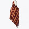 Maroon Adire scarf with diagonal orange dotted lines and fringe hem, styled on a mannequin.