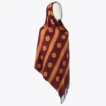 Maroon Adire scarf with diagonal orange dotted lines and fringe hem, styled on a mannequin.