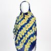 Blue Adire scarf with scattered yellow tie-dye patterns, draped in front view on a mannequin.