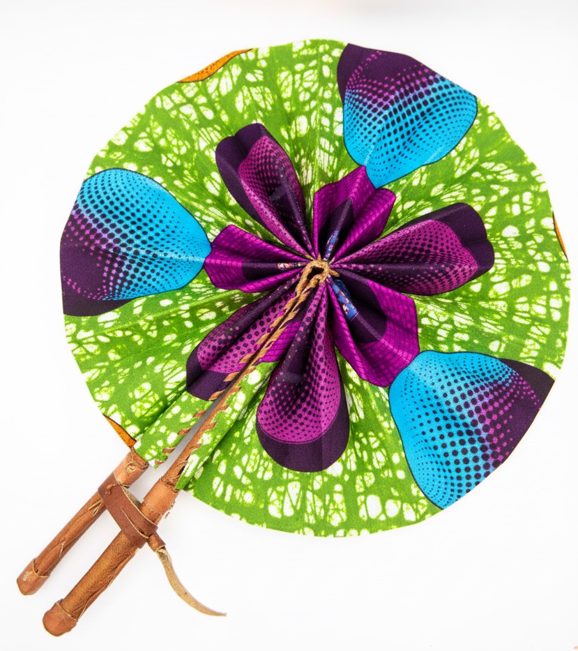 Close-up shot of an Ankara foldable fan showing the fabric texture and leather handle.