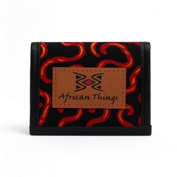African print black wallet with red and orange abstract patterns and brown African Things logo patch.