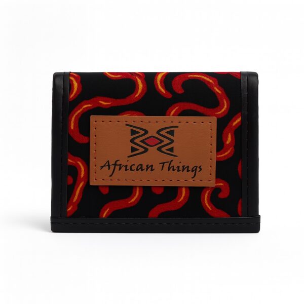African print black wallet with red and orange abstract patterns and brown African Things logo patch.