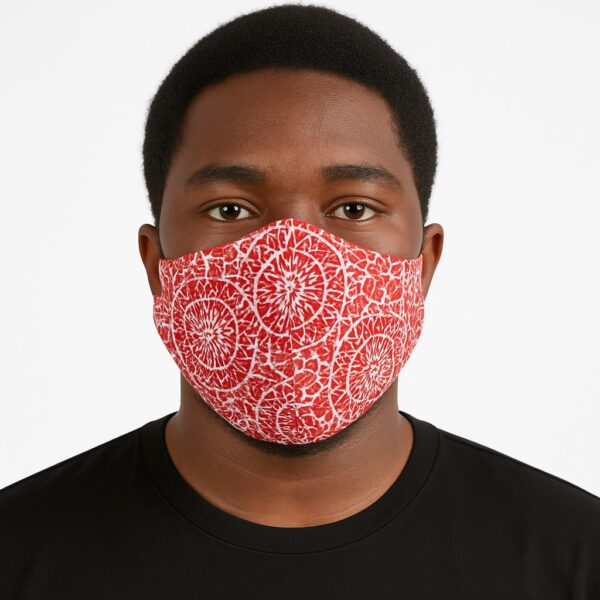 Front view of a man wearing a red Ankara face mask with cracked circular patterns. White studio background with clear details.