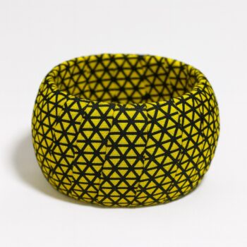 Ankara fabric bangle with yellow and black geometric triangle pattern, presented on a white background.