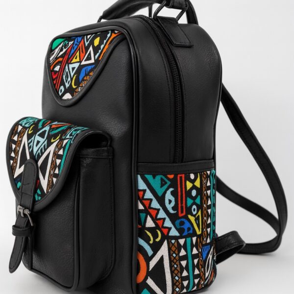 Side view of a black leather backpack with bold multicolor Ankara tribal print panels and curved silhouette.