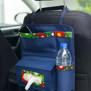 Backseat car organizer in navy blue with multicolor Ankara trim, featuring compartments for water bottle, tissue box, and phone.