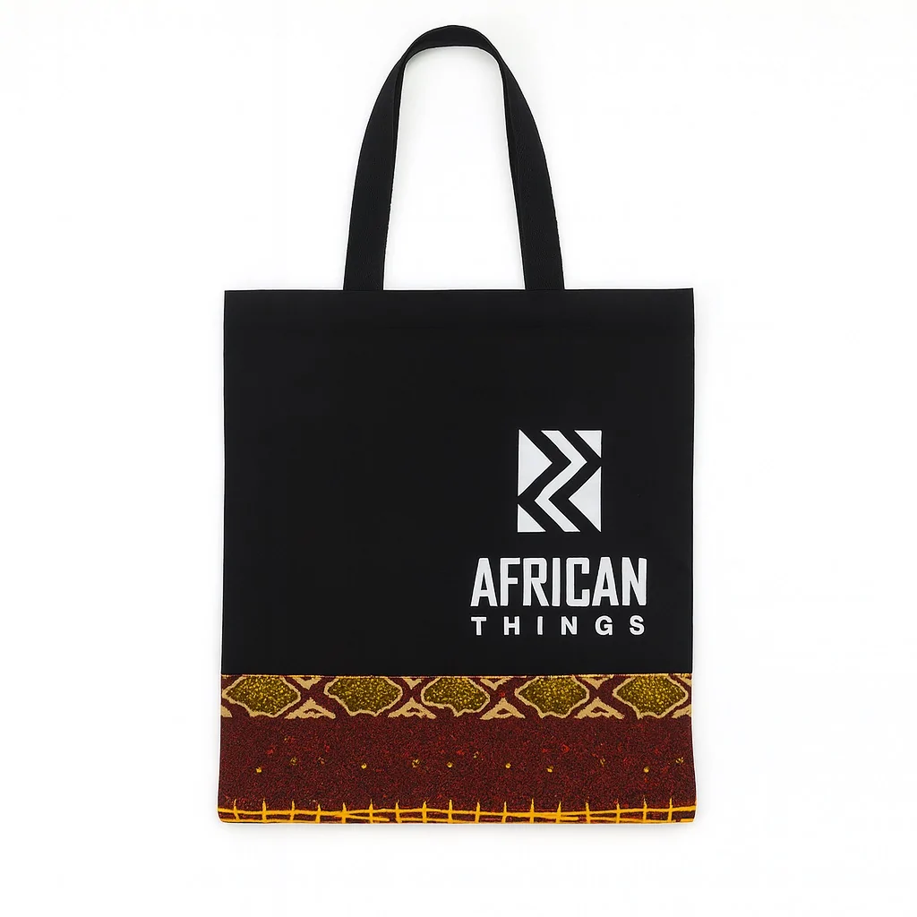 Black tote bag with "African Things" logo and Ankara fabric strip at the base