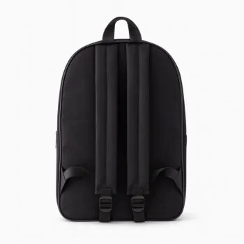 Rear view of a plain black school backpack showing padded shoulder straps and loop handle.