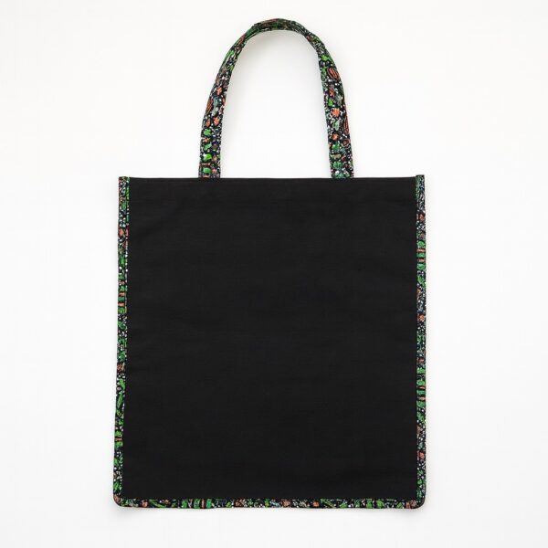 Black tote bag with vibrant Ankara fabric trim on edges and handles, perfect gift bags for souvenirs in weddings, parties, or cultural celebrations.