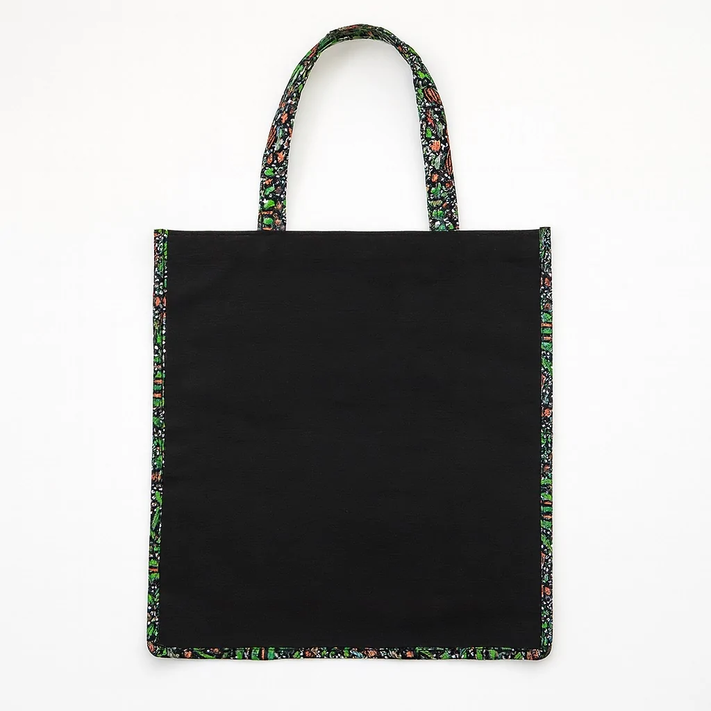 Black tote bag with vibrant Ankara fabric trim on edges and handles, perfect gift bags for souvenirs in weddings, parties, or cultural celebrations.