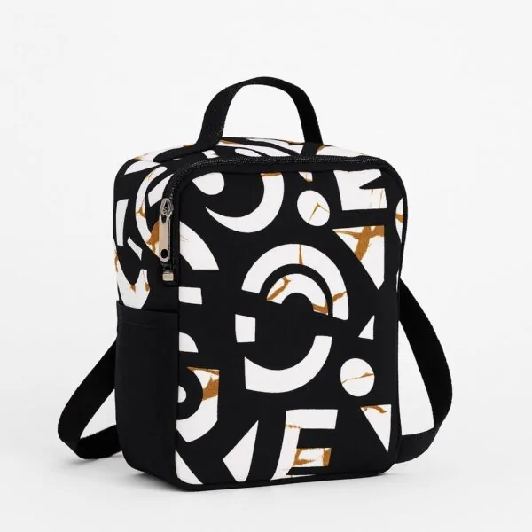 Side view of black lunch bag with bold white abstract patterns and front pocket.