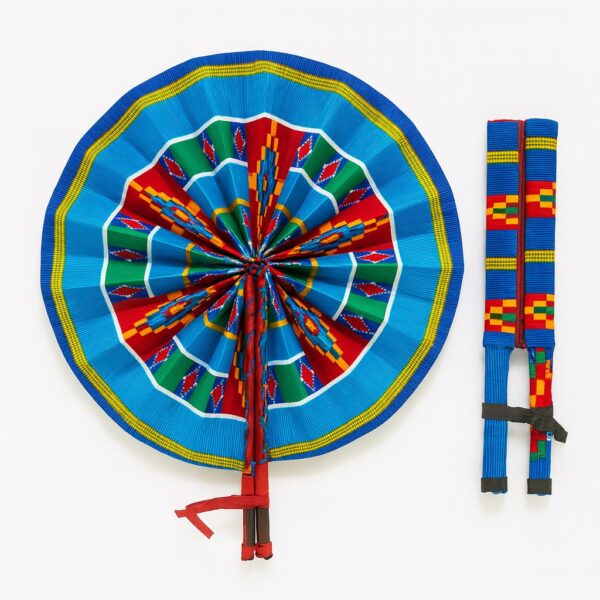 Vibrant circular hand fan in blue with Kente-inspired multicolor detailing. Comes with matching fabric-wrapped handles and leather fasteners.