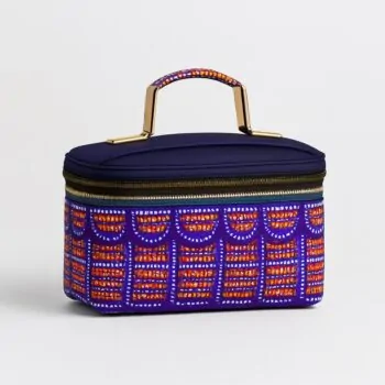 Lunch bag with green, red, and yellow abstract speckled patterns and black strap.