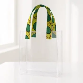 Transparent acrylic tote bag with green and yellow Ankara print handles. Transparent wedding souvenir bags Nigeria.