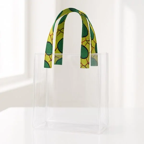 Transparent acrylic tote bag with green and yellow Ankara print handles. Transparent wedding souvenir bags Nigeria.
