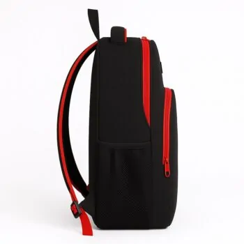 Side angle of a durable black school backpack featuring bold red trim and a mesh water bottle holder, designed for everyday student use.