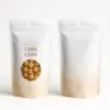 White and beige minimalist pouch – clean stand-up pouch with soft beige wave pattern, “CHIN CHIN” label, and round transparent window showcasing the snacks.