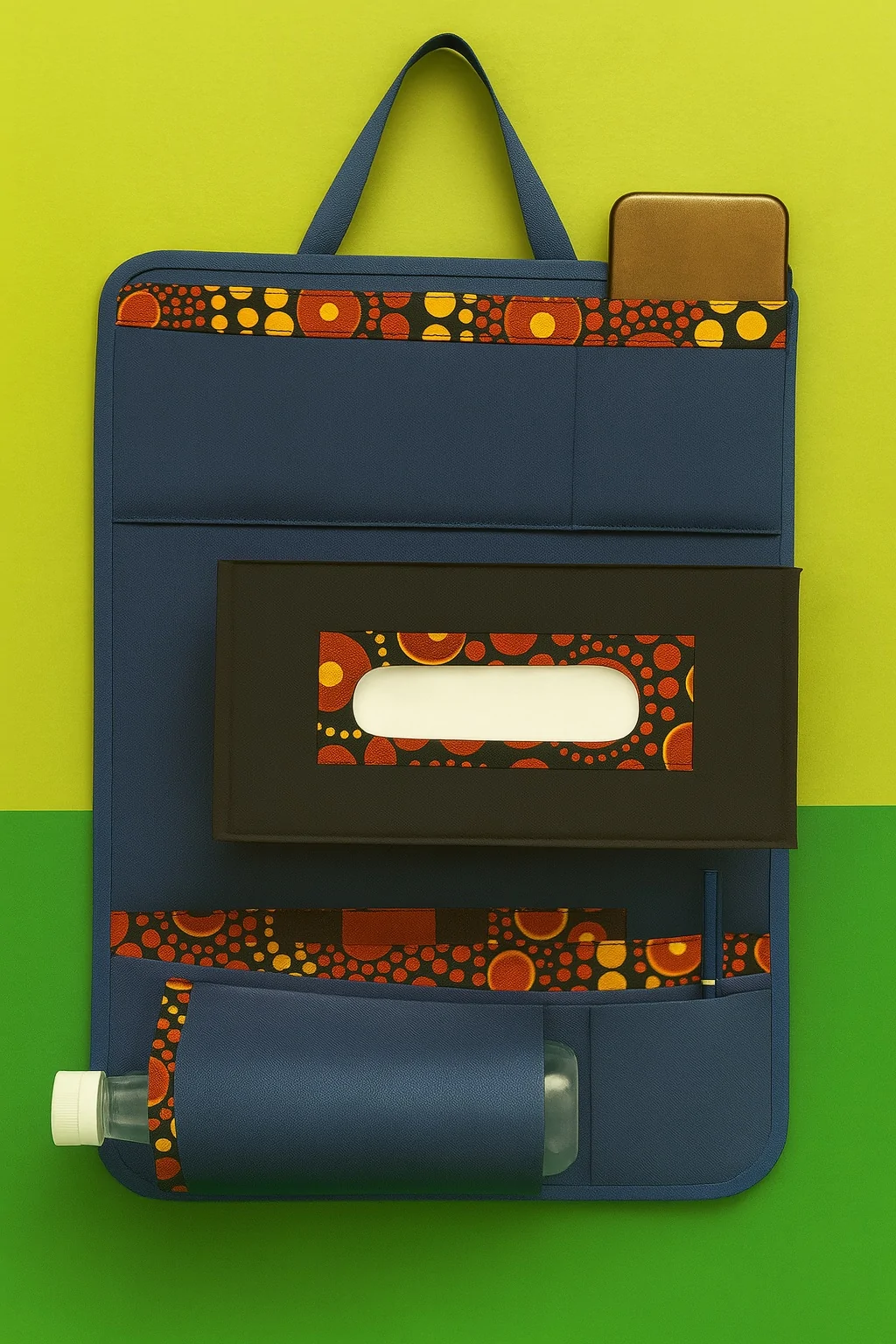Clean studio image of blue and black car organizer with orange Ankara print details, showcasing phone pocket, tissue slot, and bottle holder.