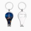 Photo of a shiny silver metal nail cutter keychain featuring a full-color printed image of the Lekki-Ikoyi Bridge at night on the front, with the back showing the integrated bottle opener