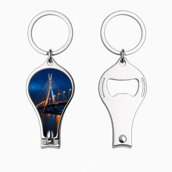 Photo of a shiny silver metal nail cutter keychain featuring a full-color printed image of the Lekki-Ikoyi Bridge at night on the front, with the back showing the integrated bottle opener