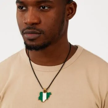 African male model wearing a Nigeria map-shaped necklace pendant.