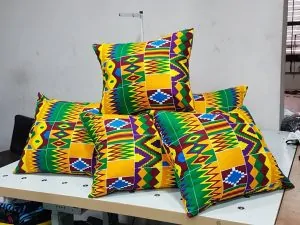 Colorful African print throw pillows on a desk