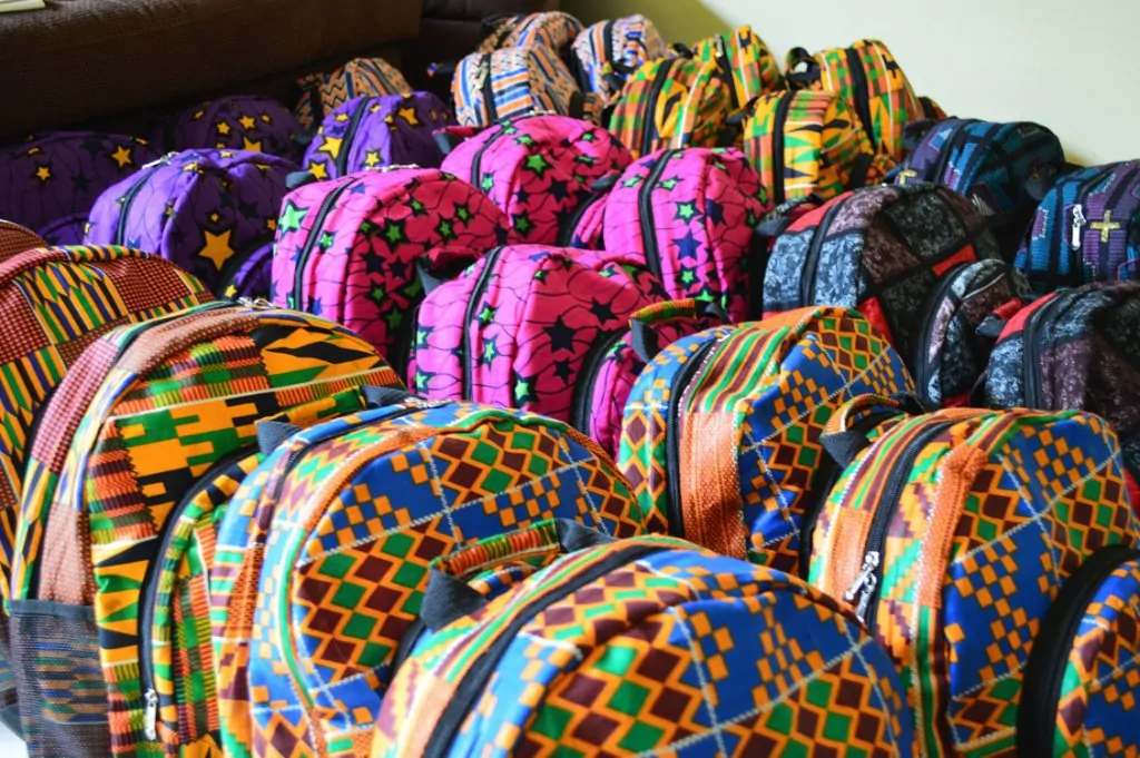 Group of colorful African print souvenir items (backpacks).