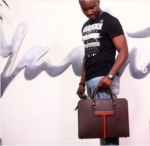 A man holding a brown leather laptop bag. Great for souvenir Ideas for corporate events & business.