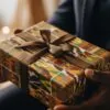 A man handing over an African print gift box to another man