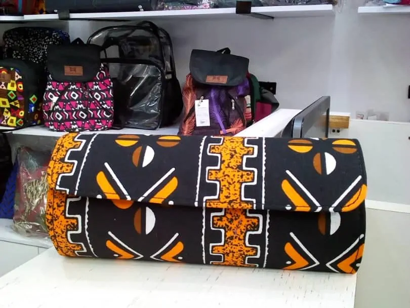 Handmade Souvenir Bags in Nigeria | Unique + Personalized 3 Orange African Print clutch bag
