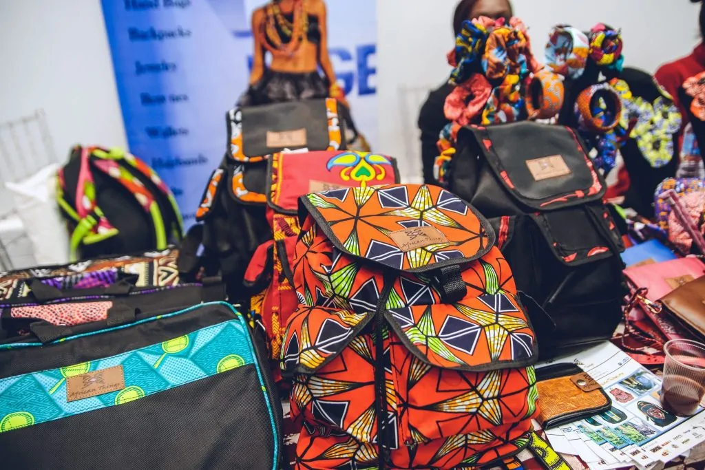 Collection of different Ankara/African print bags on a table.