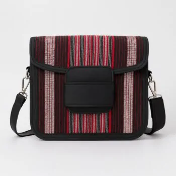 Front view of an African print Aso Oke side bag with red, black, and silver vertical stripes, black leather flap, and shoulder strap on a white background.