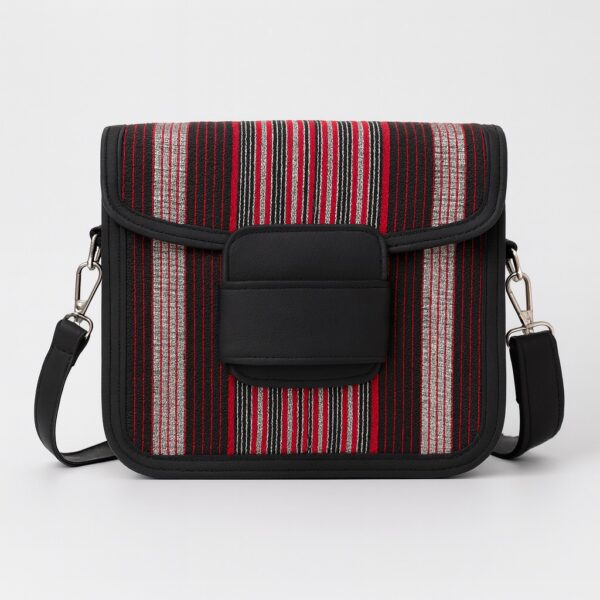 Front view of an African print Aso Oke side bag with red, black, and silver vertical stripes, black leather flap, and shoulder strap on a white background.