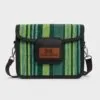Front-facing image of a green-striped Aso Oke side bag with the "African Things" brown leather brand patch on the flap.