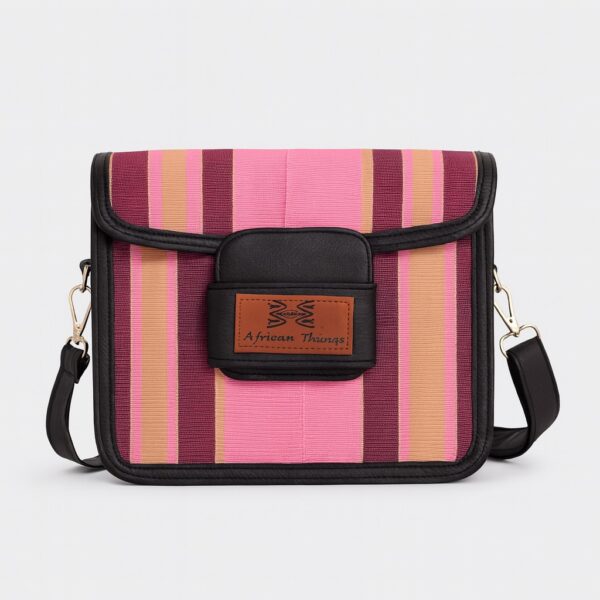 Close-up front view of a pink and maroon Aso Oke side bag featuring the "African Things" leather logo patch.