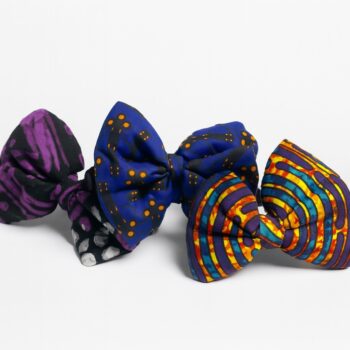 Three Ankara fabric bows in purple, blue, and multicolor patterns on a white background.
