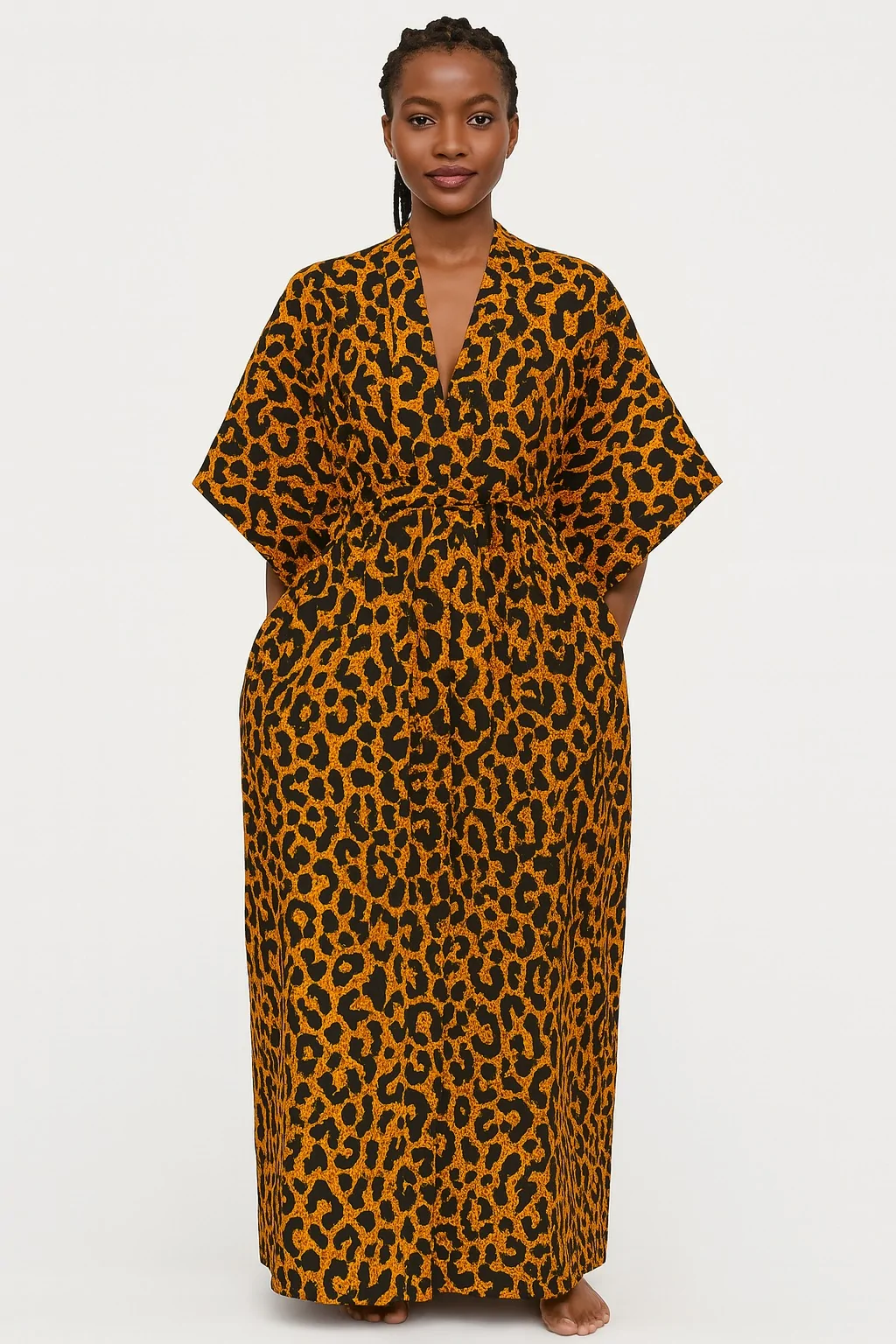 Woman wearing an orange and black leopard print kimono, standing barefoot.