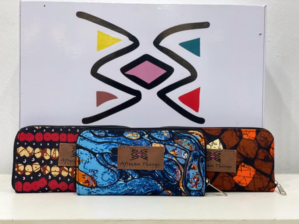 Vibrant African print female wallet with colorful patterns, multiple compartments, and a secure closure for style and functionality.