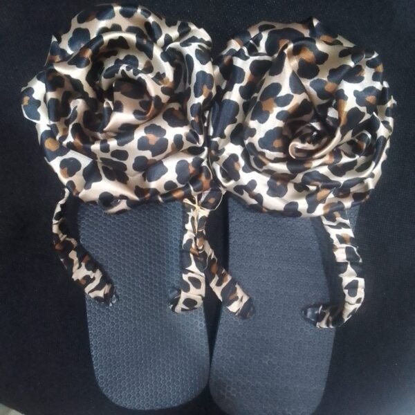 Colorful African print flip flops with vibrant patterned straps,