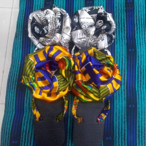 "Vibrant African print flip flops with colorful patterned straps, cushioned sole, and a durable non-slip design for comfort and style.