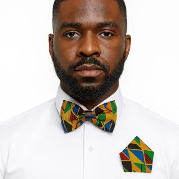 Man wearing kente African print bow tie and matching pocket square with white shirt.