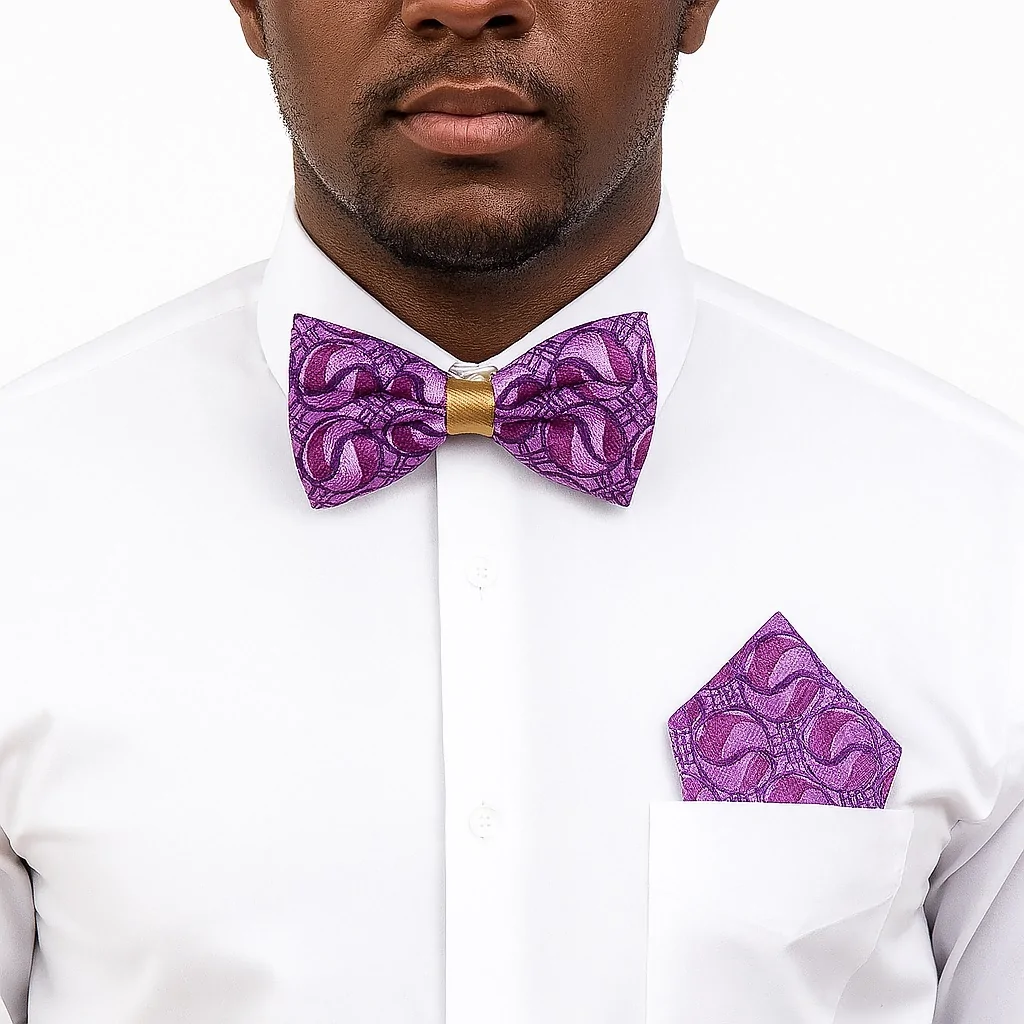 Man wearing purple African print bow tie and matching pocket square with white shirt.