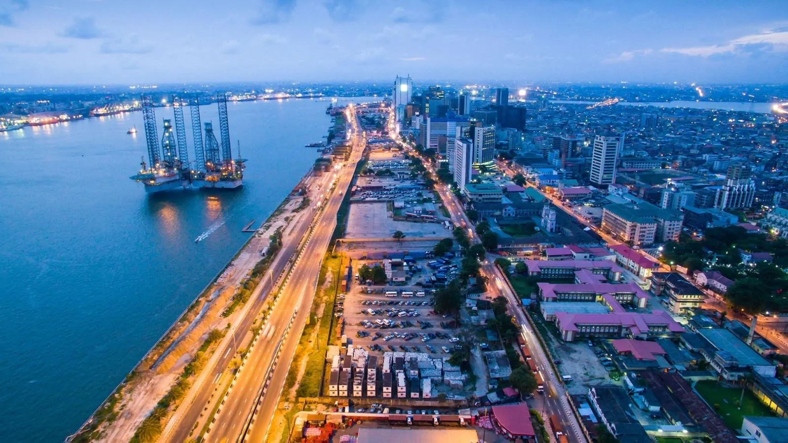 Ready to Thrive? Discover Africa’s Best Cities for Young Professionals to Live, Work & Succeed 2 Dynamic cityscape of Lagos, Nigeria at dusk, a top African city for young professionals.