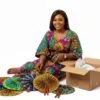 A lady with a collection of African foldable hand fans, ready for wholesale shipment.