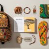 Collection of African gift items/souvenirs including an Ankara backpack, a Kente flip flop, a Dashiki shirt, African fridge magnets etc