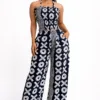 Black and white Ankara two-piece outfit featuring a smocked halter top and wide-leg palazzo pants