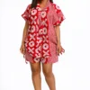 Red-and-white African print two piece set featuring a short sleeved kimono-style top and matching shorts with a tie detail