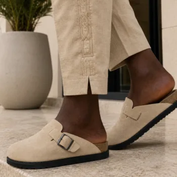 A person wearing handmade clog mules