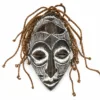 Carved African wooden mask wall art with white geometric details and natural fiber accents